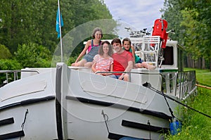 Family vacation, travel on barge boat in canal, parents with kids having fun on river cruise