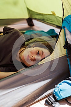 family vacation and travel. joyful boy lies in a tent. travel with children. hiking in the forest and living in a tent