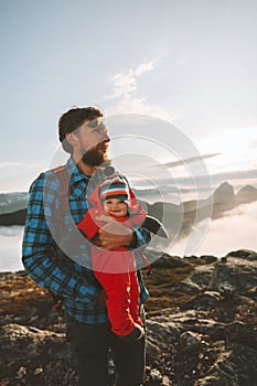 Family vacations father with baby traveling in mountains