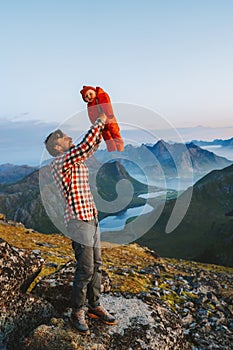 Family vacations father hiking with infant baby outdoor active healthy lifestyle traveling in Norway summer trip