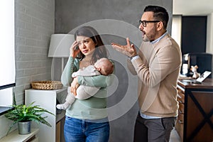 Family violence. Aggressive nervous man arguing with his wife who has postpartum depression