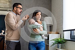 Family violence. Aggressive nervous man arguing with his wife who has postpartum depression