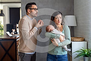 Family violence. Aggressive nervous man arguing with his wife who has postpartum depression