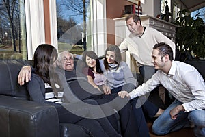 Family visiting elderly relative at a retirement h
