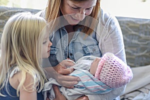 Family visiting newborn baby in hospital room