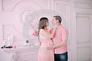 Family waiting for baby`s birth. A pregnant woman and her husband wearing white clothing