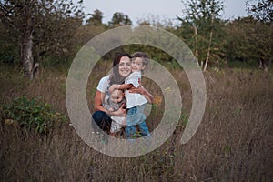 Family walk in autumn in the garden. Happy young woman with child