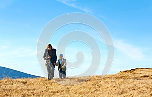 Family walk on autumn mountain plateau