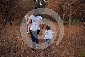 A family walk in the fall park evening