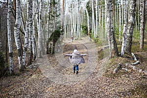 Family walk outdoor. happy child runs along forest road with his arms spread out like wings. concept of freedom