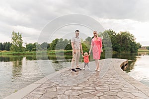 Family walk in the park. Family walks in the park. Man, woman and child in nature