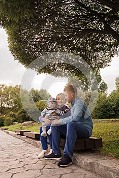 Family walk in the park. Family walks in the park. Man, woman and child in nature