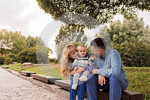 Family walk in the park. Family walks in the park. Man, woman and child in nature