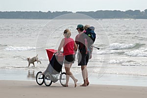 Family walk by the sea