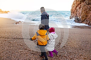 Family walk by the sea, in the winter time. Spending time