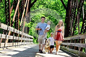 Family Walking Across Bridge