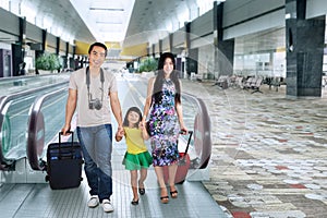 Family walking in the airport hall