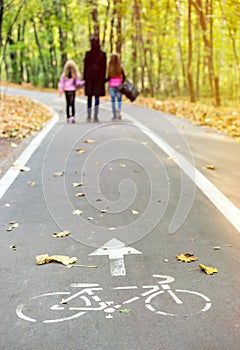 Family walking in autumn park