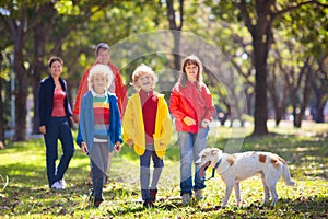 Family walking in autumn park. Fall fun