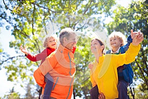 Family walking in autumn park. Fall fun