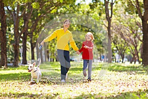 Family walking in autumn park. Fall fun