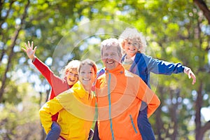 Family walking in autumn park. Fall fun