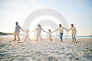 Family, walking and beach with holding hands for love in outdoor on vacation with sunshine. Care, generations and