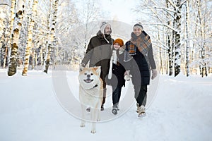 Family Walking Dog in Winter