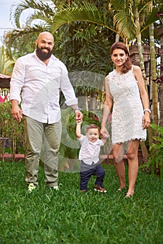 Family walking on green grass