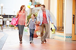 Family Walking Through Mall With Shopping Bags photo