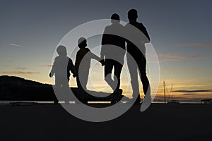 Family walking outdoors at sunset