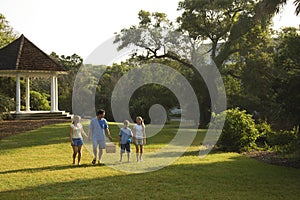 Family walking in park.