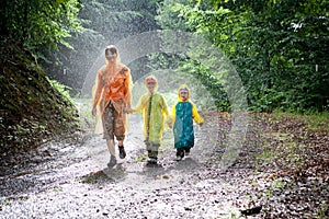 Family walking in the rain