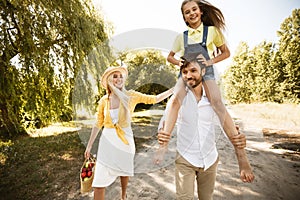 Family Walking Spending Time Together Going On Picnic In Countryside