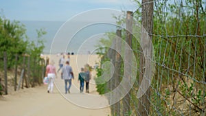 Family is walking to the beach