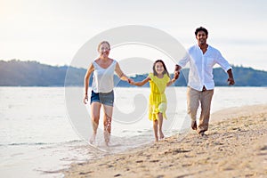 Family walking on tropical beach