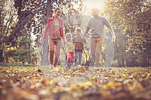 Family walking trough public park. On the move.