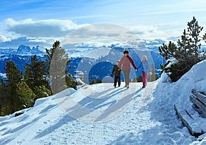 Family walking on winter mountain slope