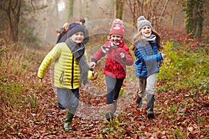 Family Walking Through Winter Woodland