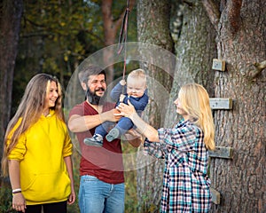 The family walks in the park in the summer, has fun, plays.