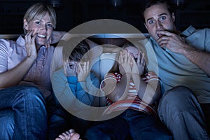 Family Watching Scary Programme On TV