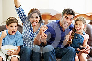 Family Watching Soccer Celebrating Goal