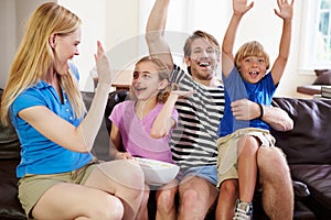 Family Watching Soccer on TV Celebrating Goal