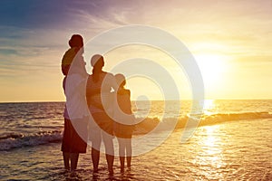 family watching the sunset on the beach