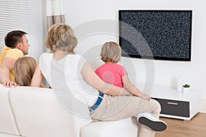 Family Watching Television Showing No Signal