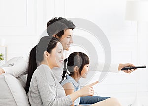 Family watching TV in living room