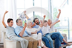 Family watching tv on sofa