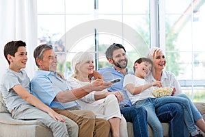 Family watching tv on sofa