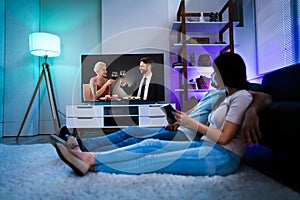 Family Watching TV Through Tablet Streaming Television