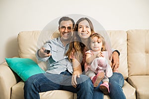 Family watching tv together